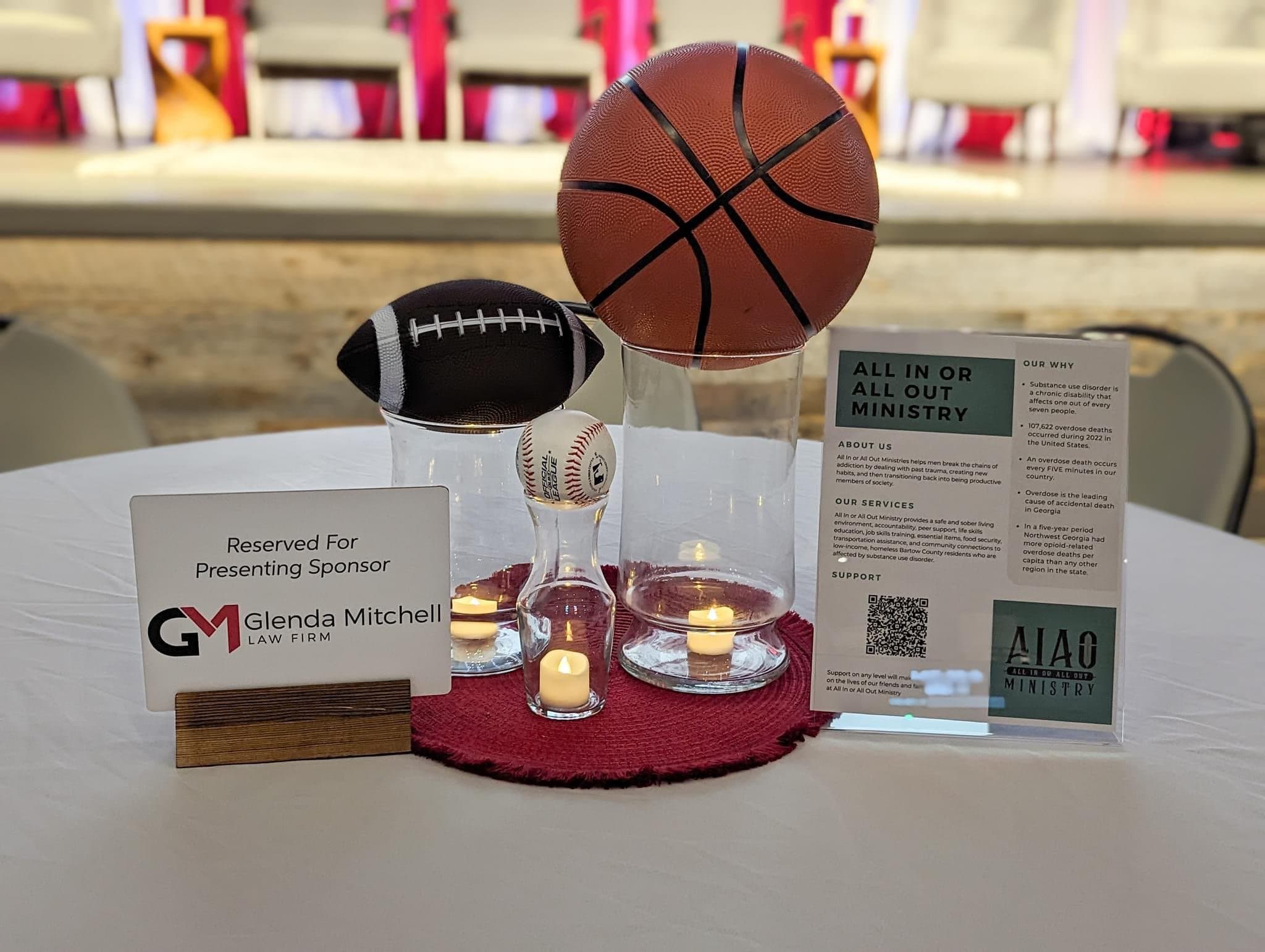 Table display with sports-themed decorations reserved for Glenda Mitchell Law Firm.