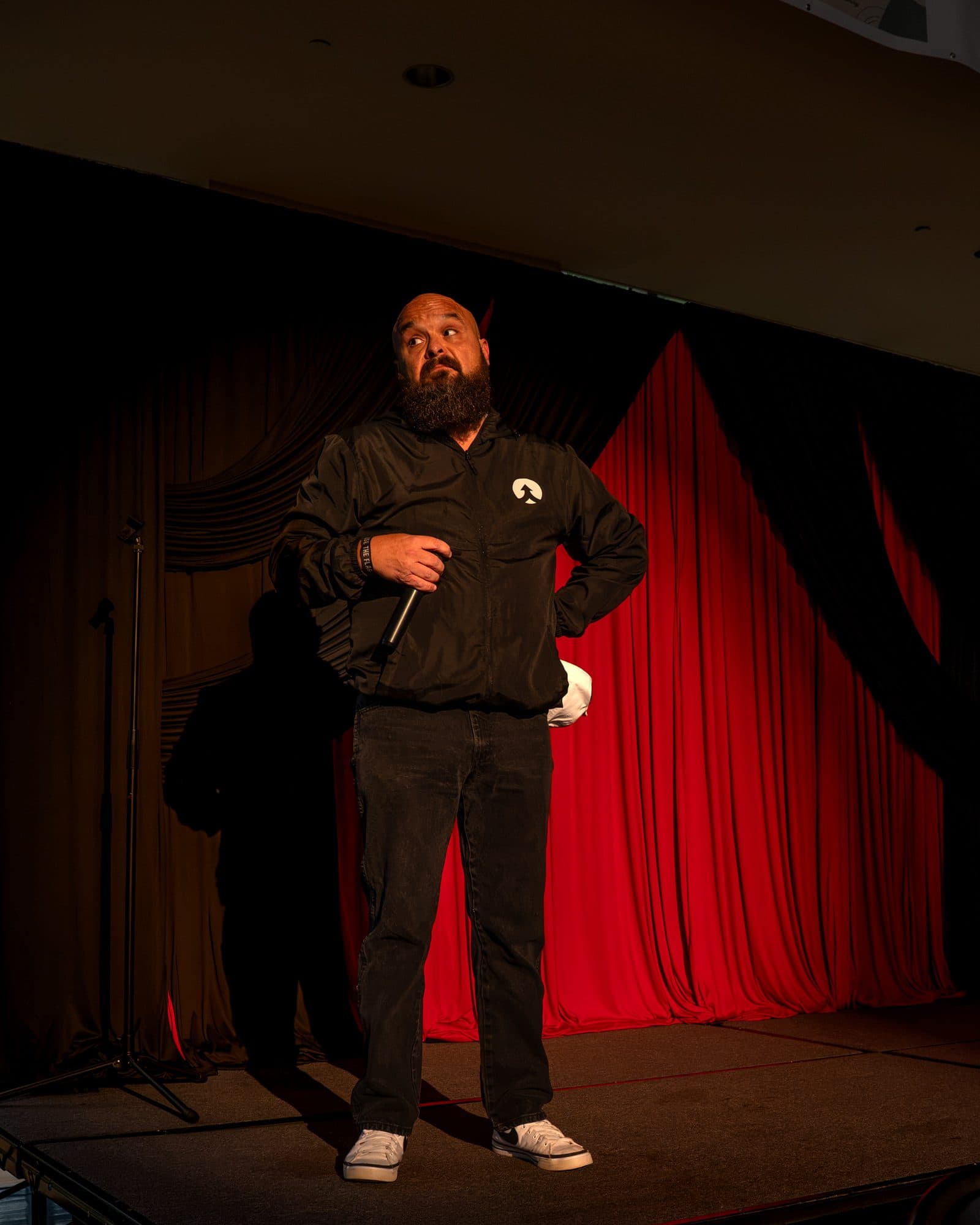 Comedian performing a stand-up set on stage at Mic Drop Masters 2026.