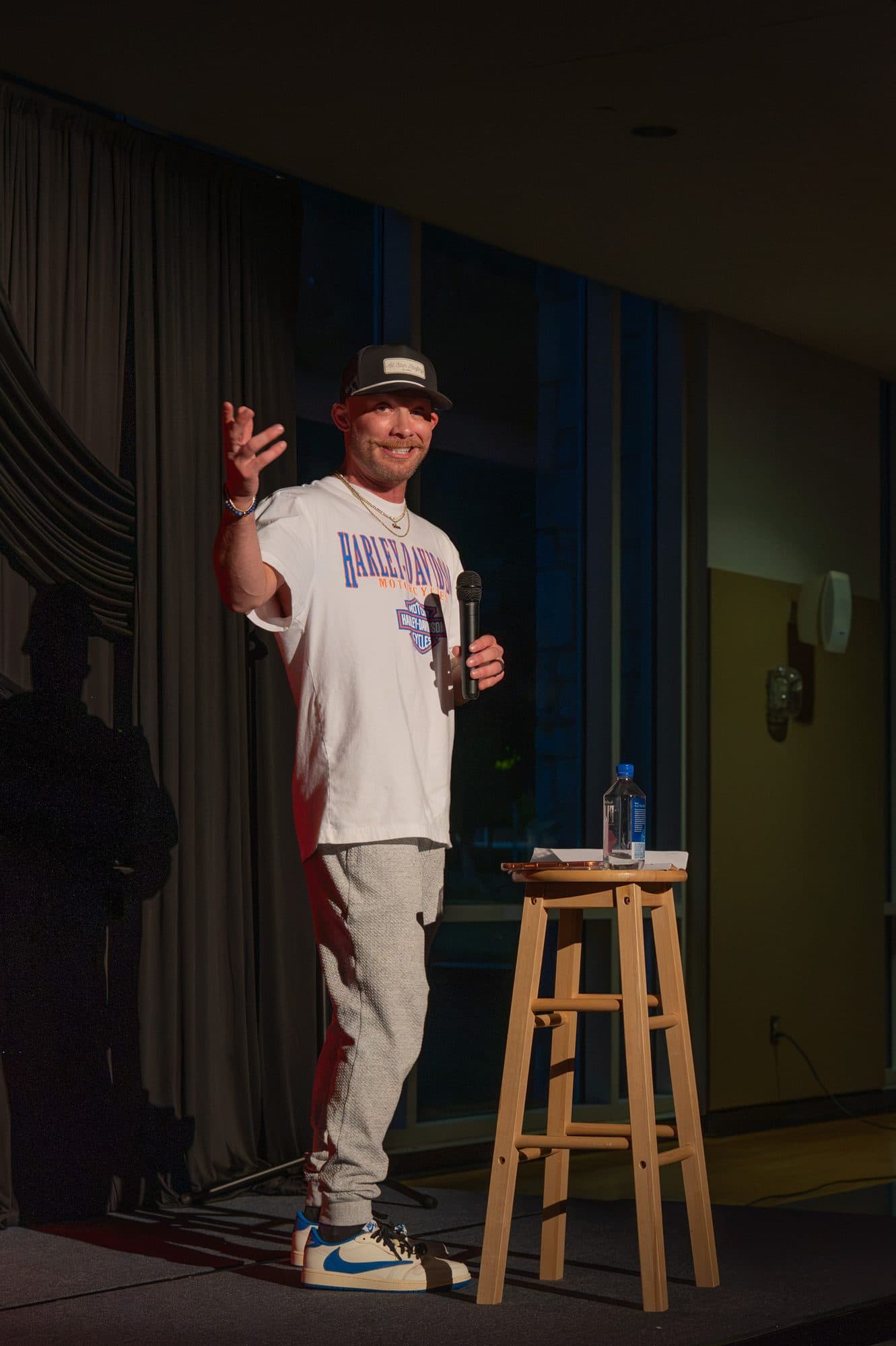 Comedian performing a stand-up set on stage at Mic Drop Masters 2026.