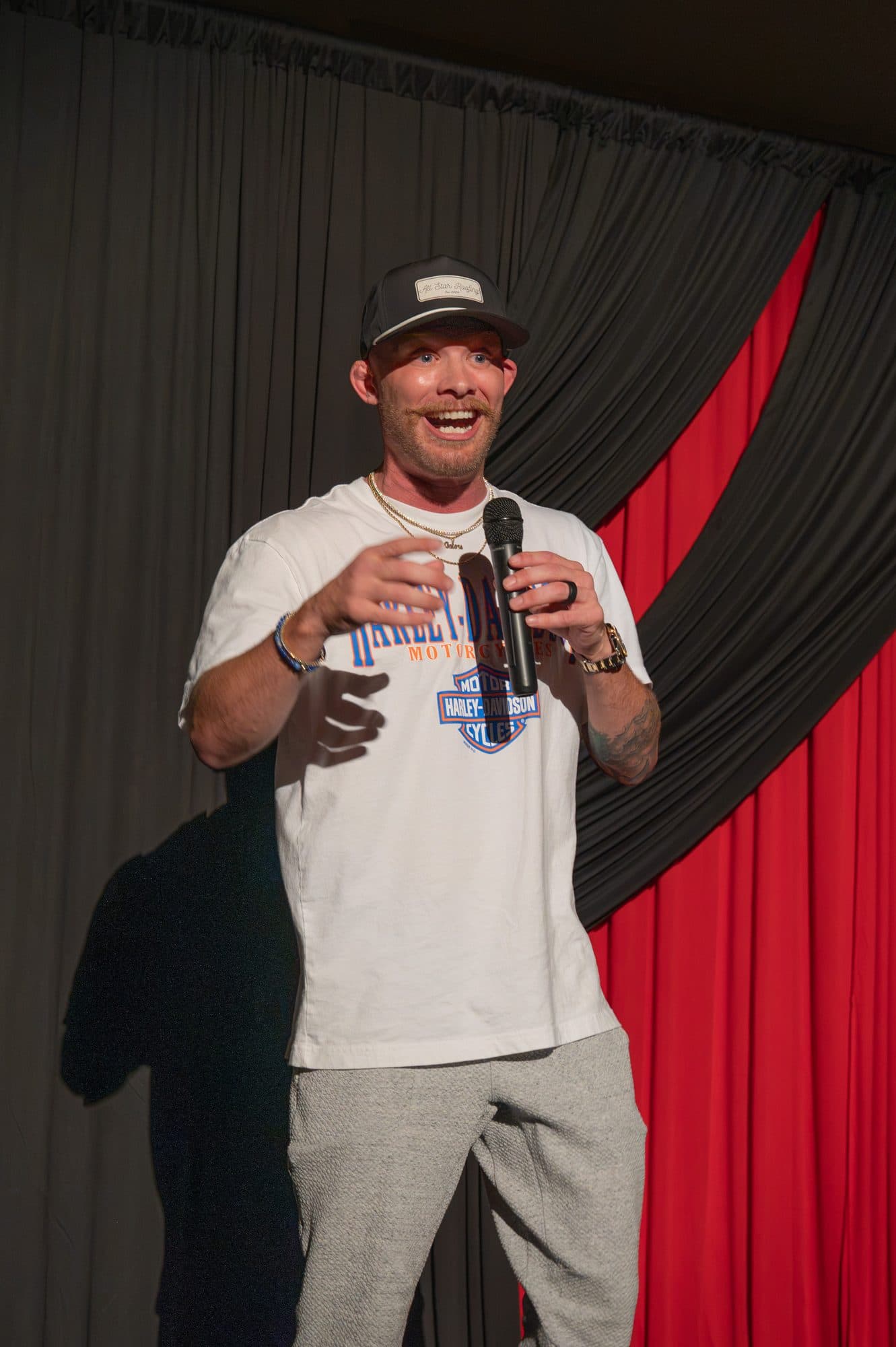 Comedian performing a stand-up set on stage at Mic Drop Masters 2026.