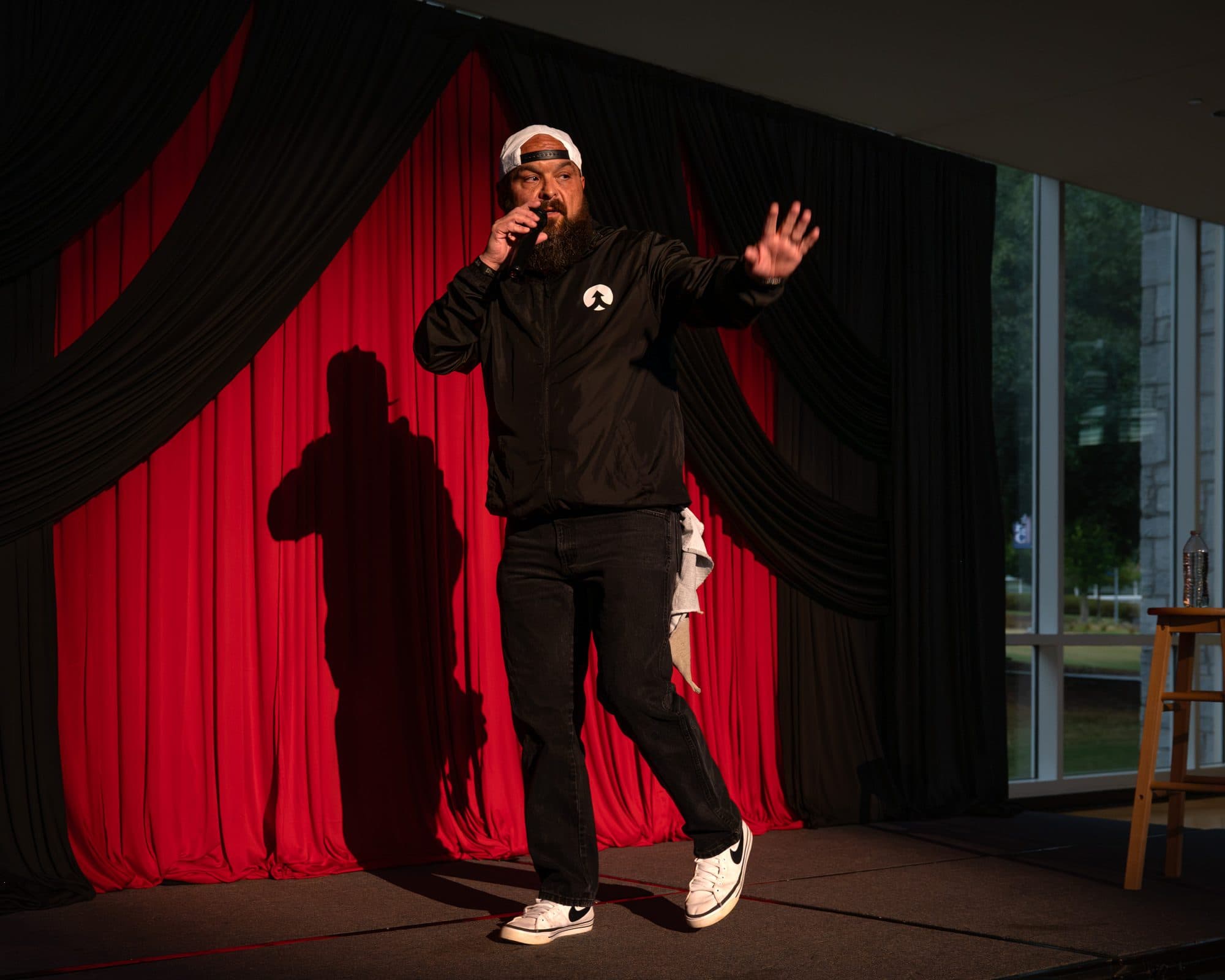 Comedian performing a stand-up set on stage at Mic Drop Masters 2026.