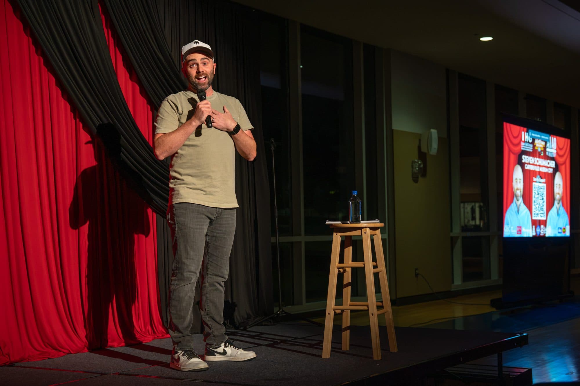 Comedian performing a stand-up set on stage at Mic Drop Masters 2026.