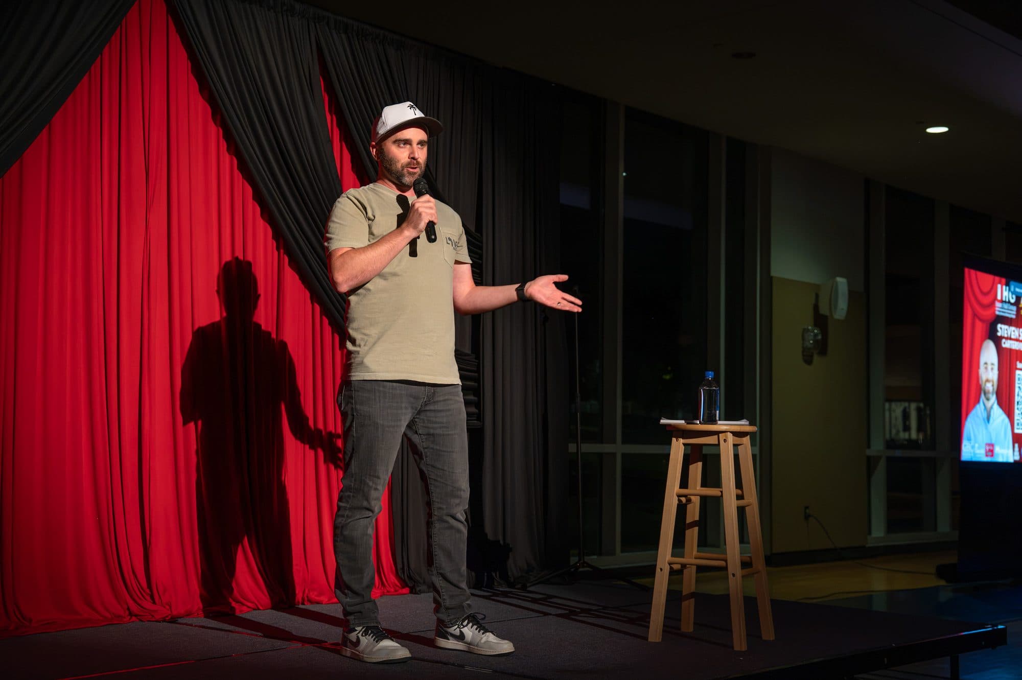 Comedian performing a stand-up set on stage at Mic Drop Masters 2026.