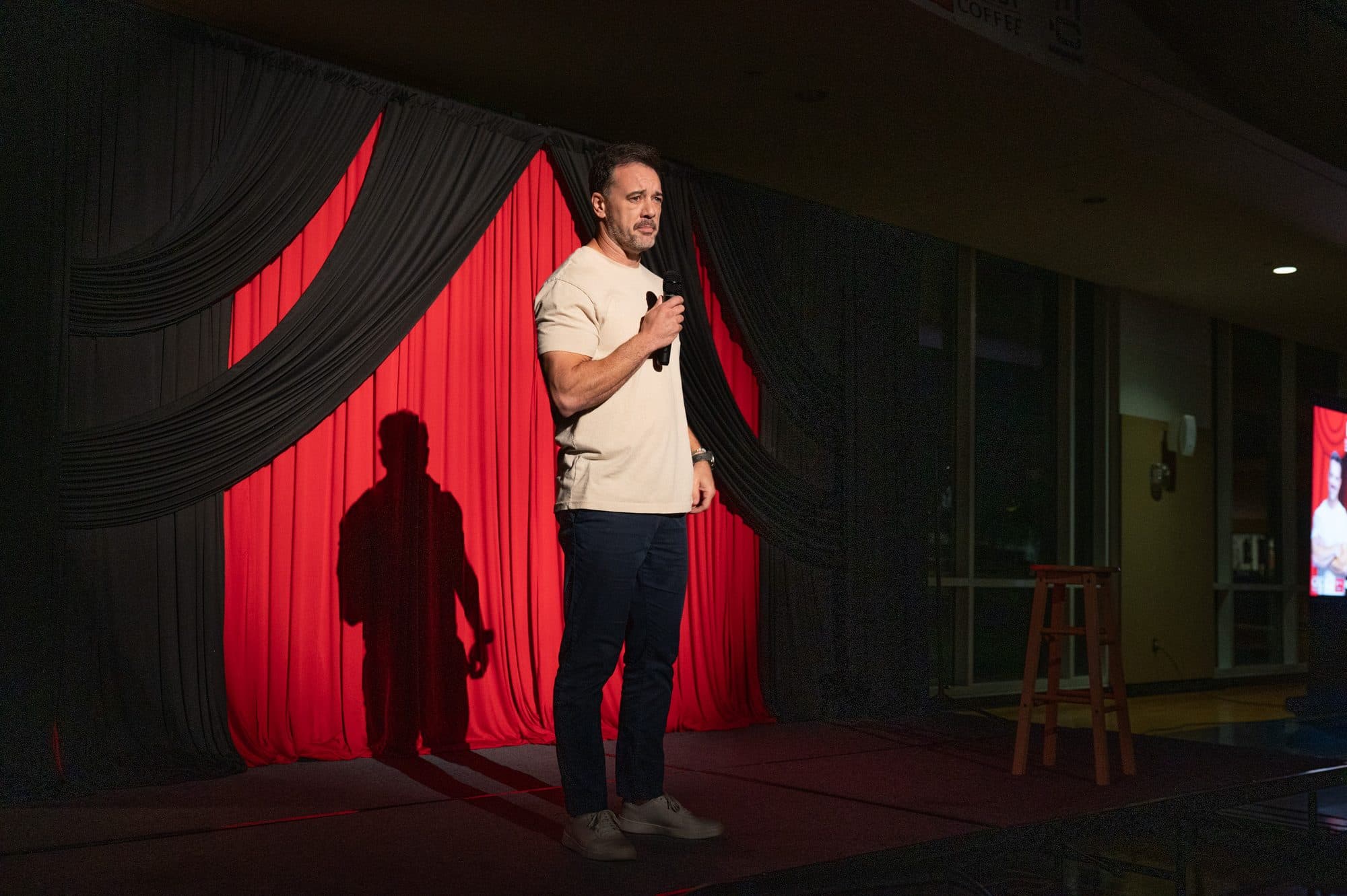 Comedian performing a stand-up set on stage at Mic Drop Masters 2026.