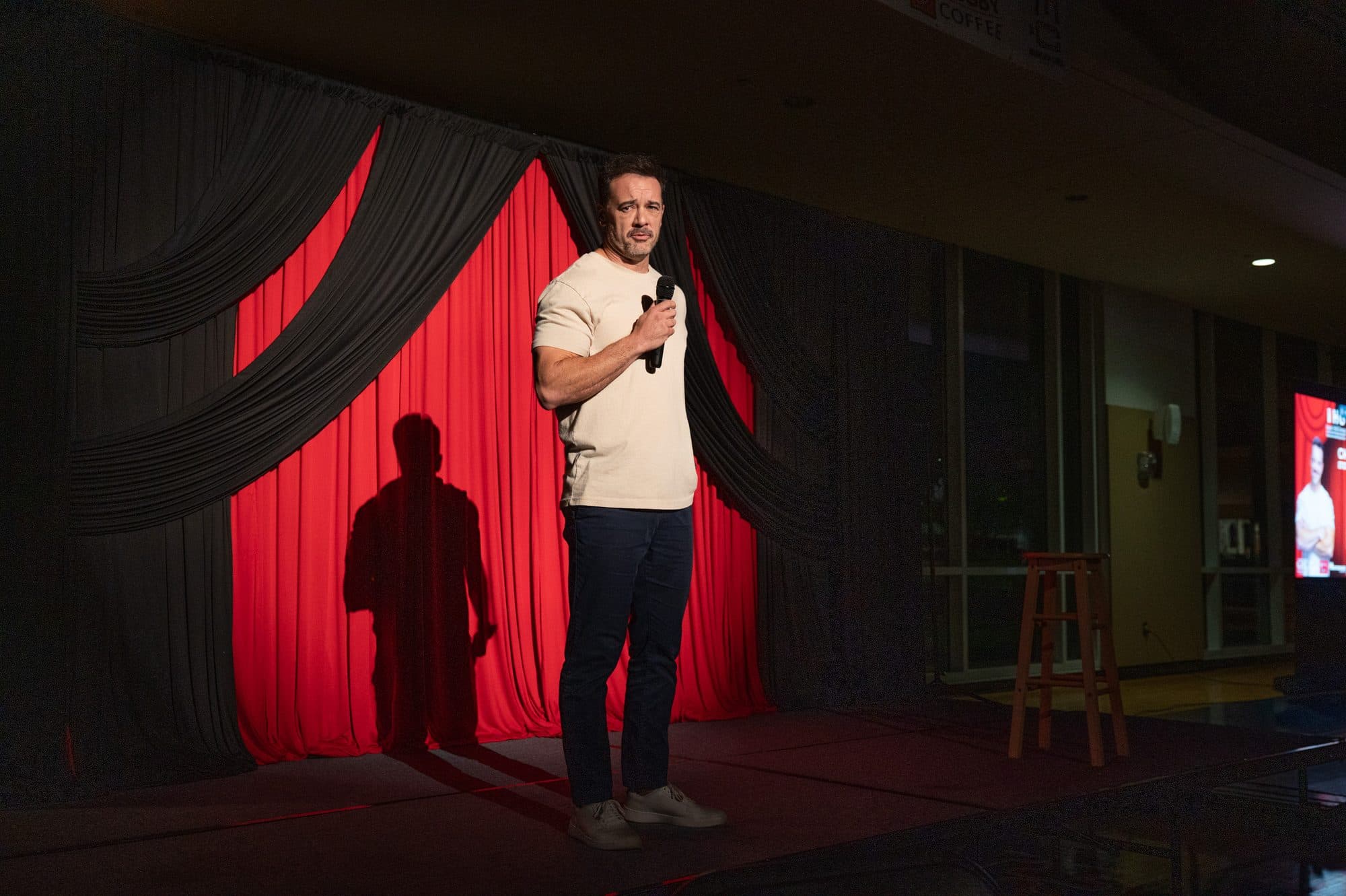 Comedian performing a stand-up set on stage at Mic Drop Masters 2026.