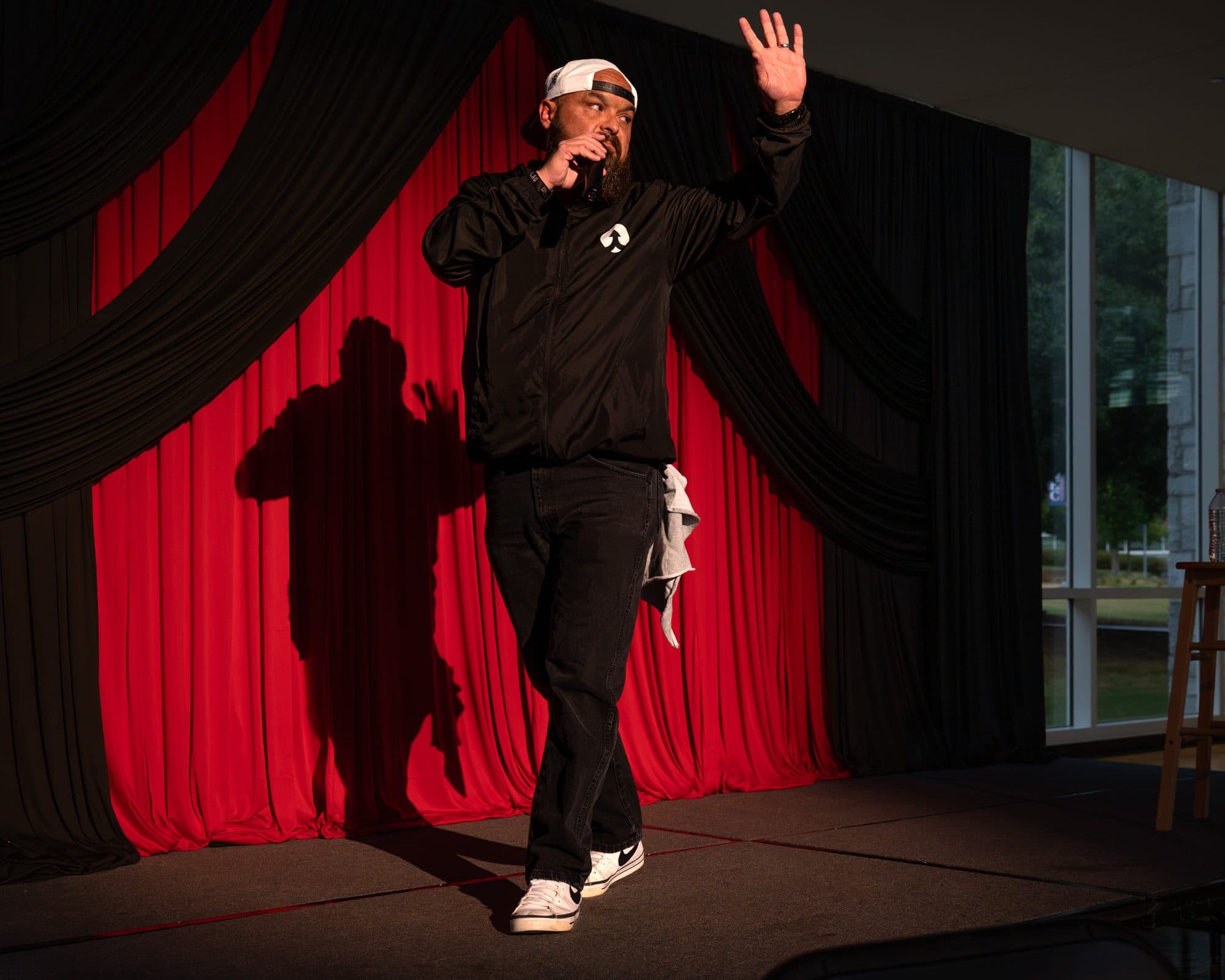 Comedian performing a stand-up set on stage at Mic Drop Masters 2026.