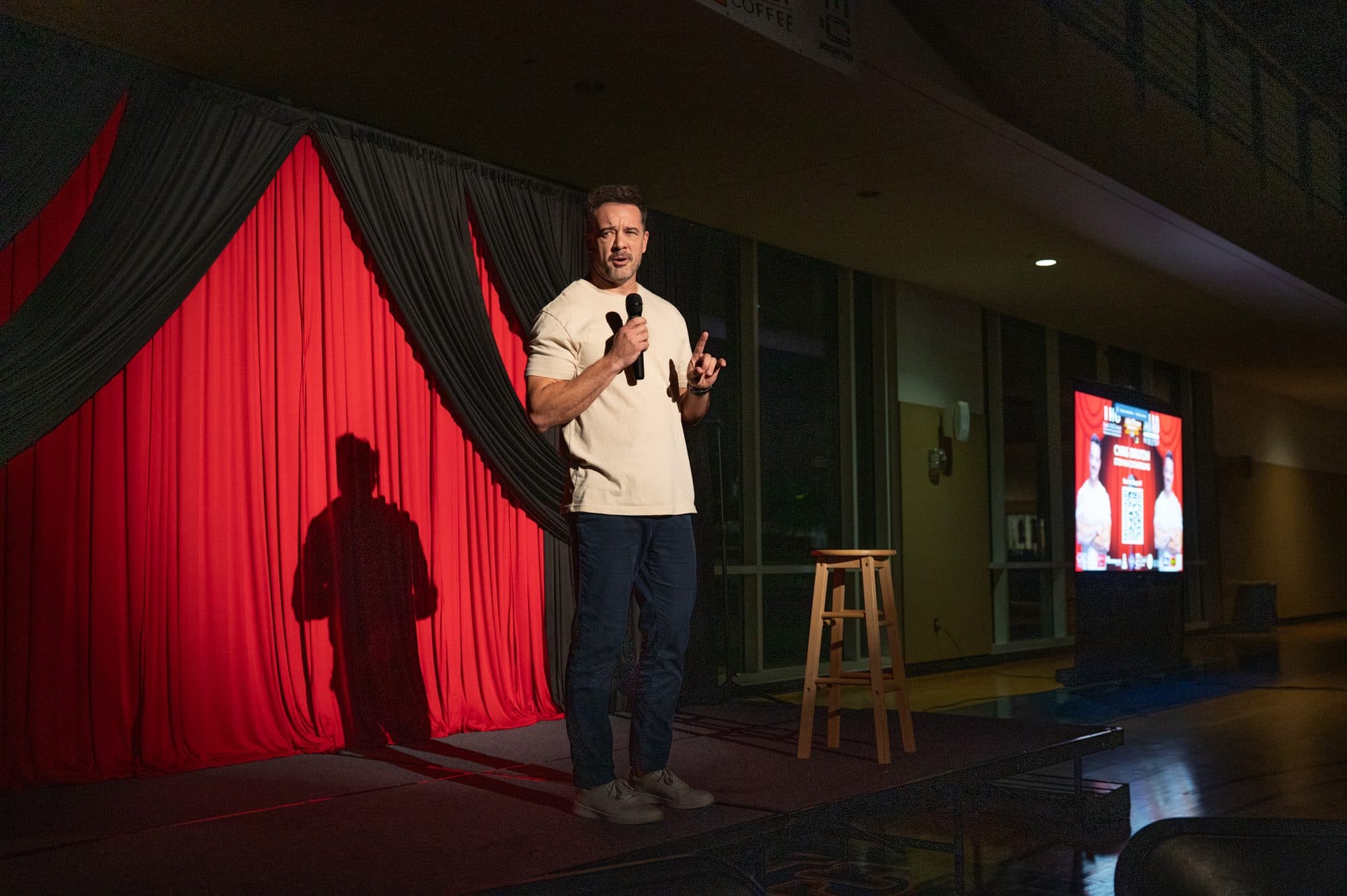 Comedian performing a stand-up set on stage at Mic Drop Masters 2026.