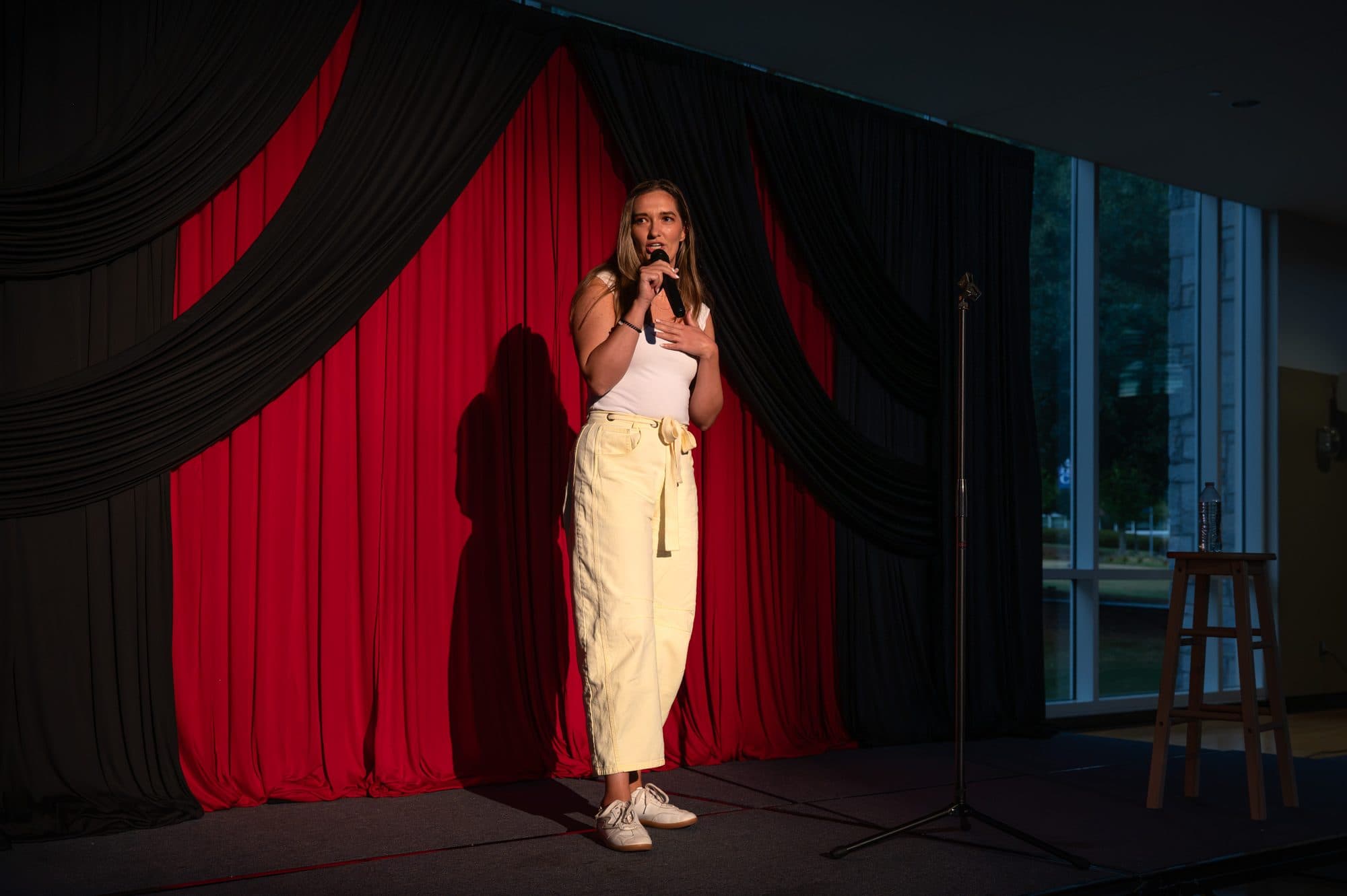Comedian performing a stand-up set on stage at Mic Drop Masters 2026.
