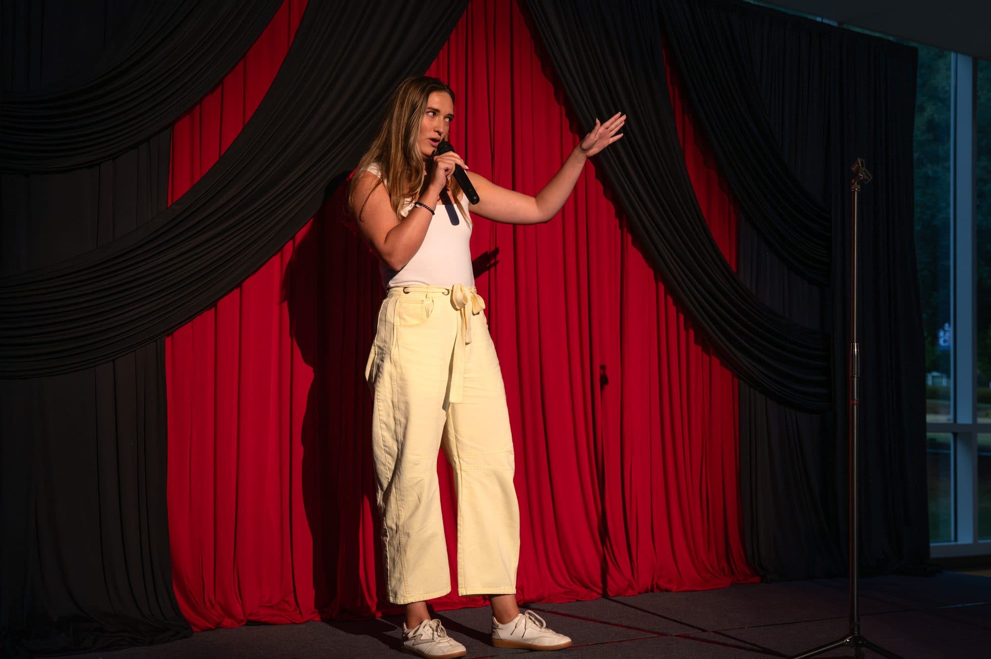 Comedian performing a stand-up set on stage at Mic Drop Masters 2026.