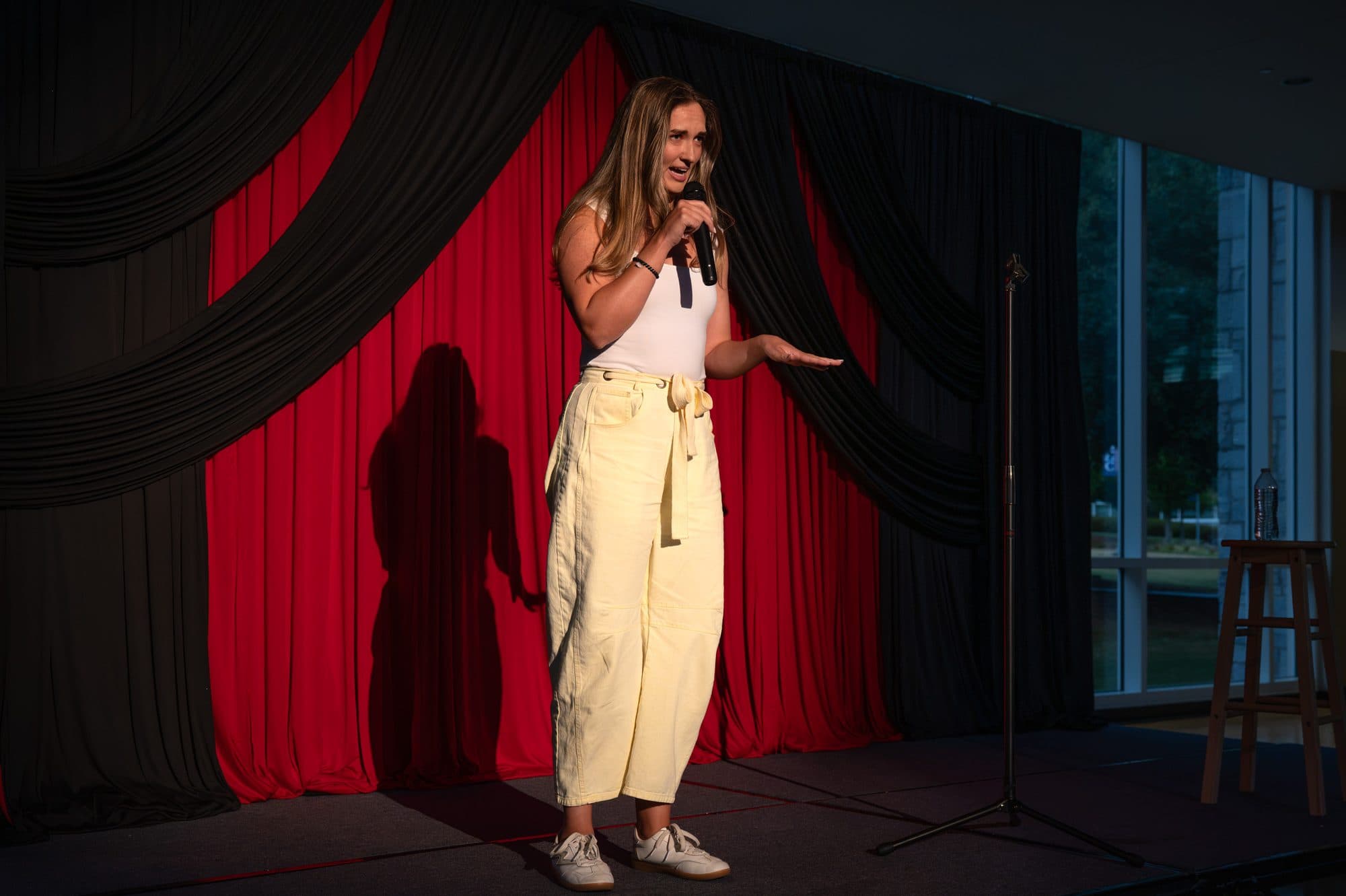 Comedian performing a stand-up set on stage at Mic Drop Masters 2026.