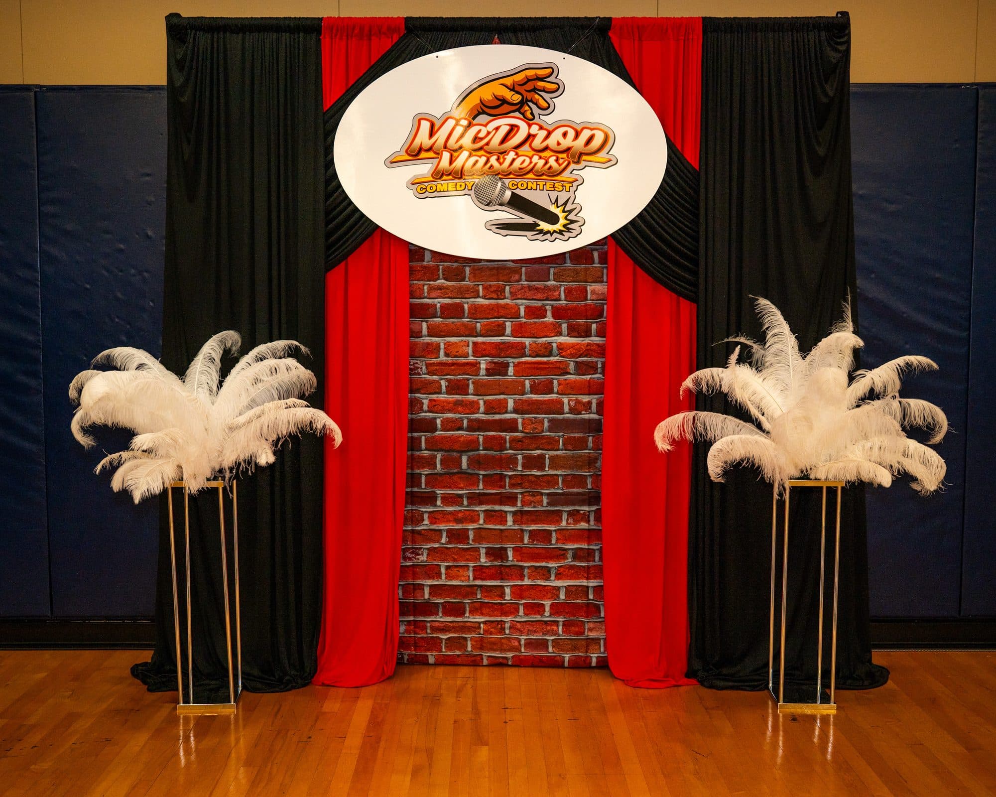 Event merchandise and signage at Mic Drop Masters 2026.