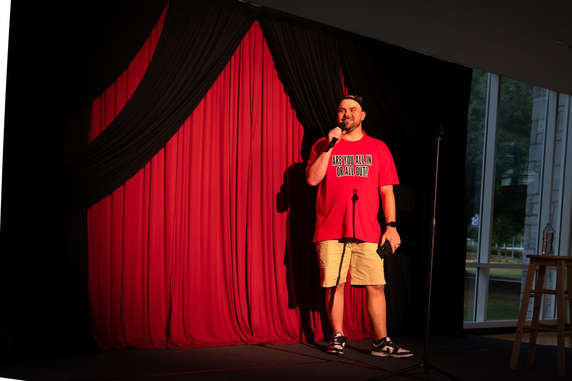 Speaker addressing the crowd at the Mic Drop Masters 2026 fundraiser.