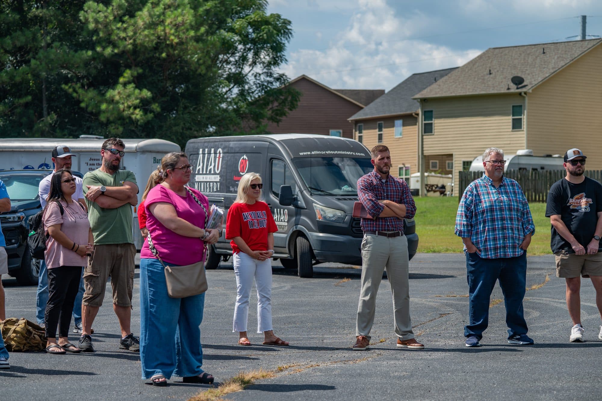 Crowd of AIAO Ministry supporters gathered in the parking lot near the Redemption Village site for the groundbreaking.